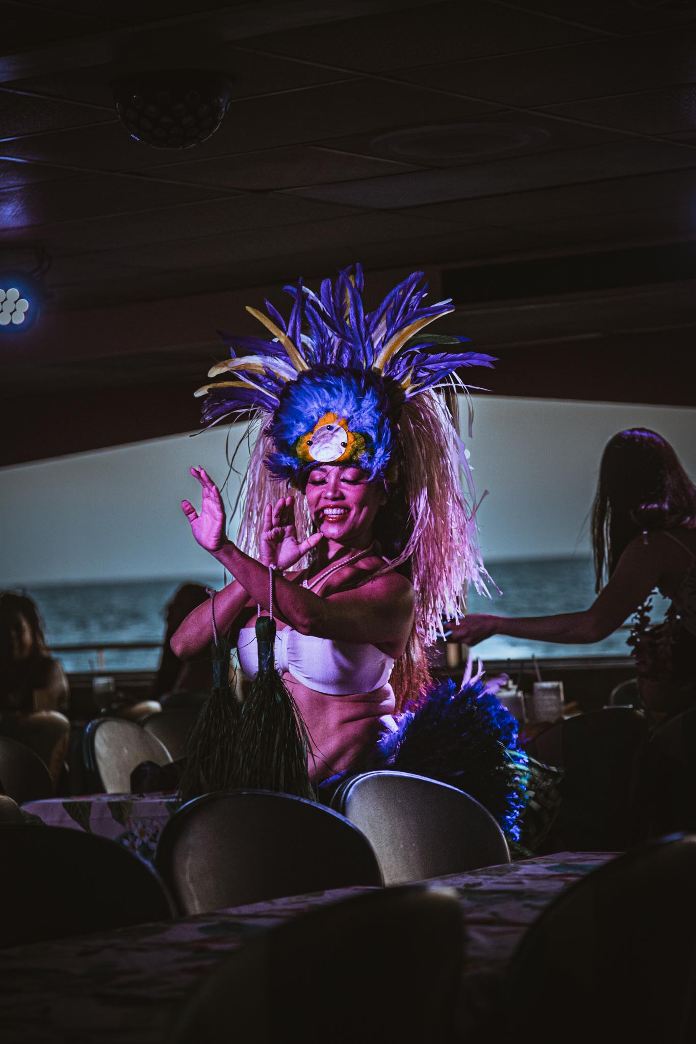 Performer mid-gesture under stage light