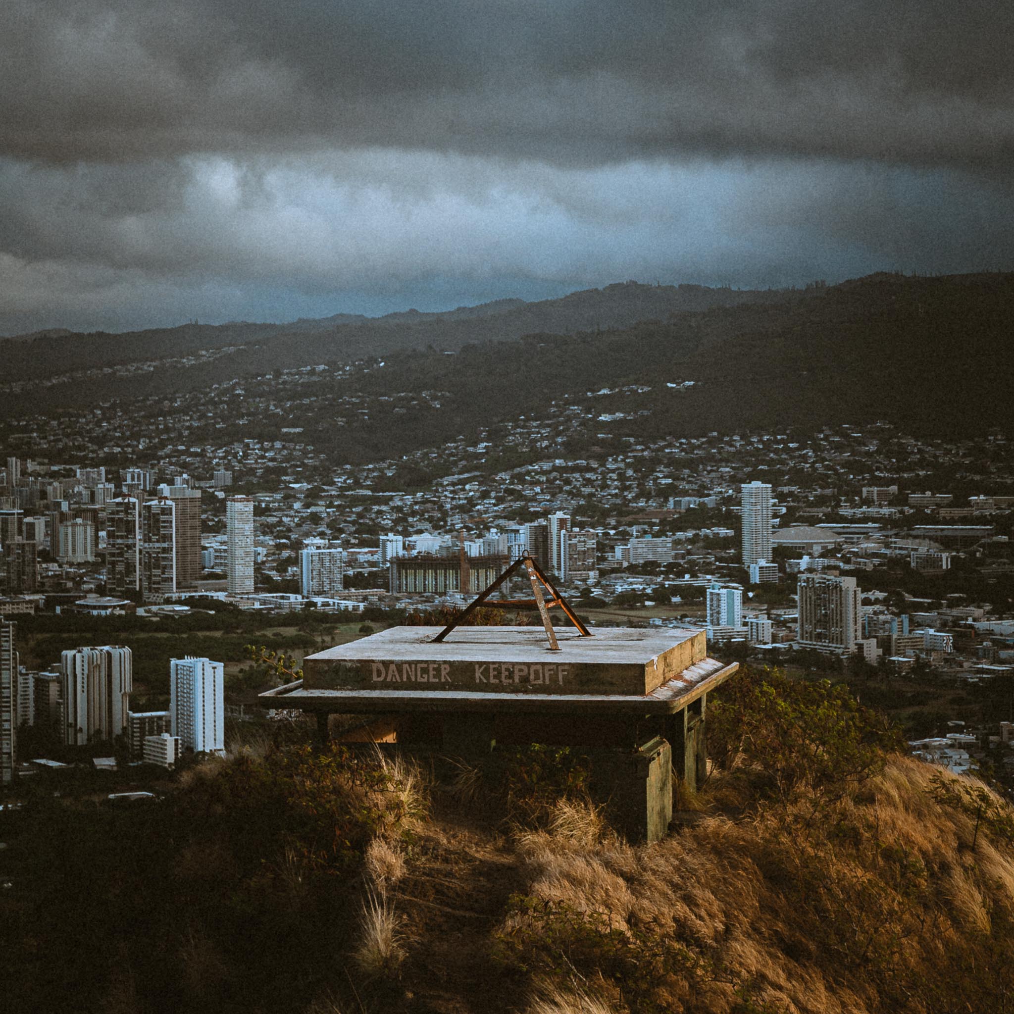 Wider view of bunker and storm-lit city