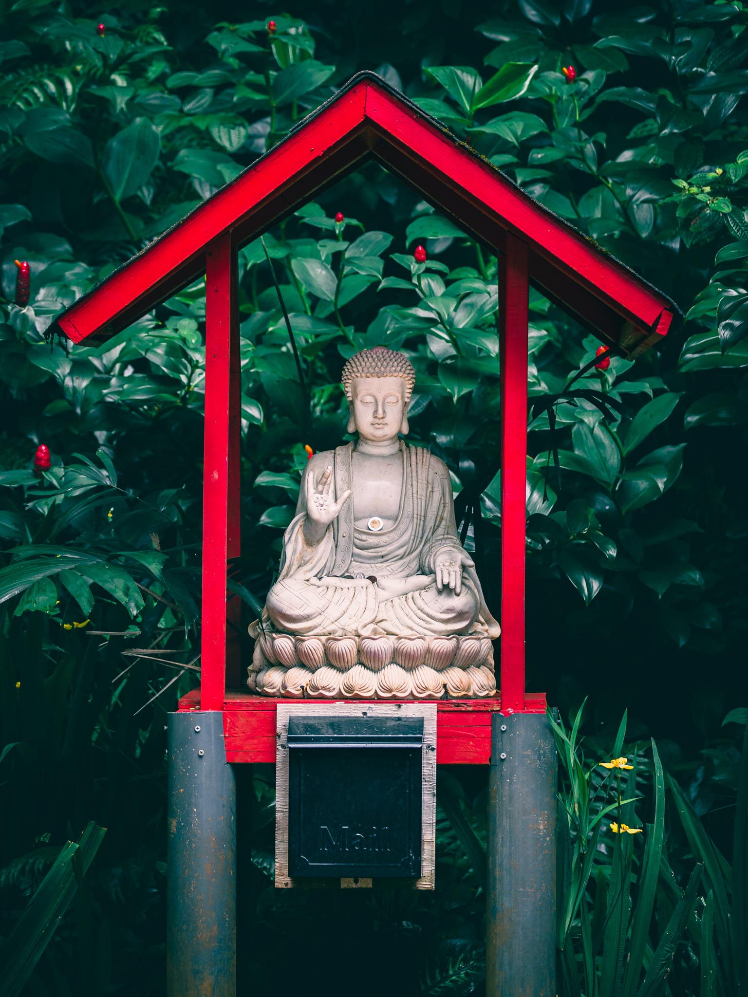 Temple Buddha detail framed by a red roofline