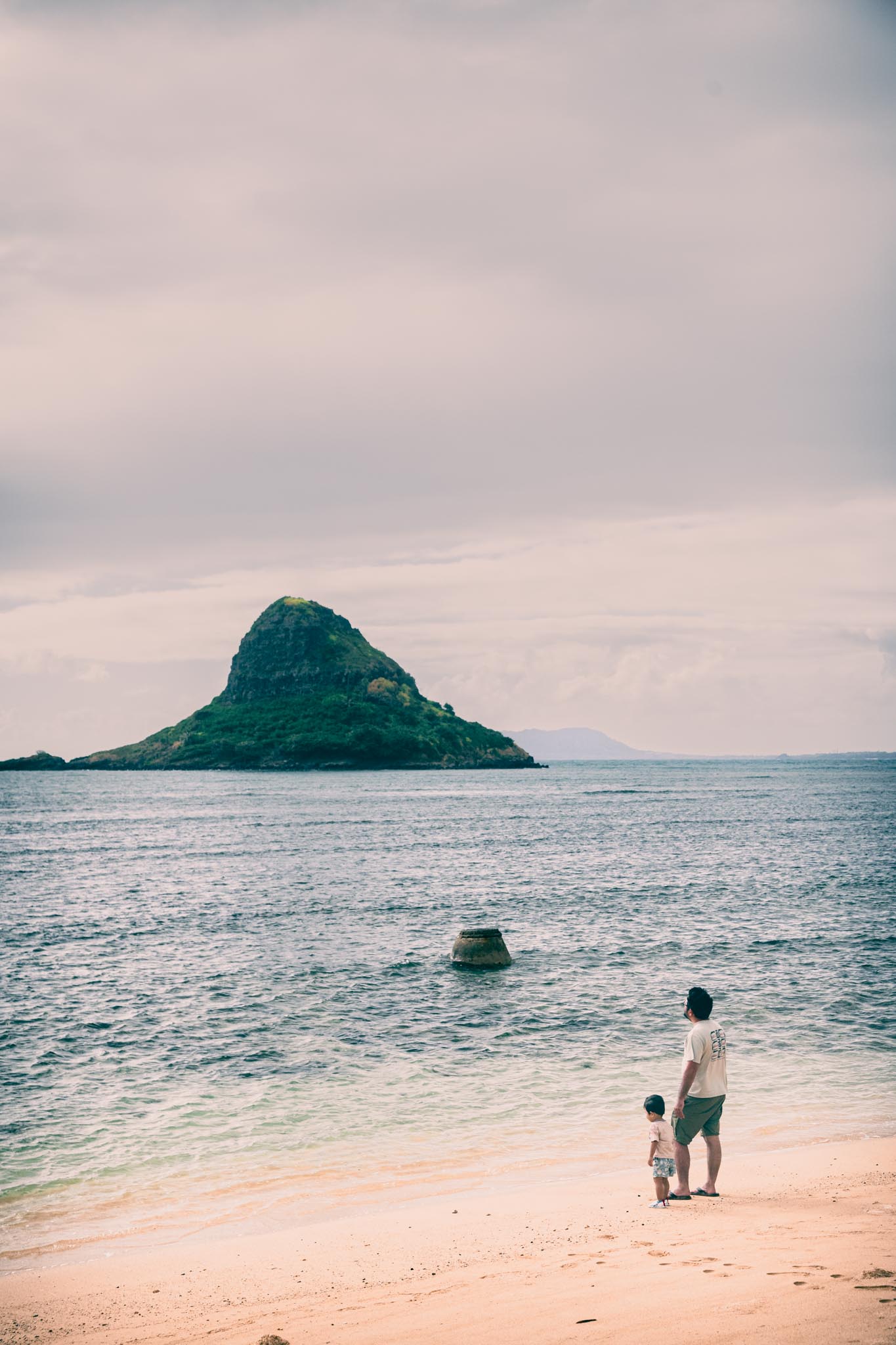 Father and child at the water's edge