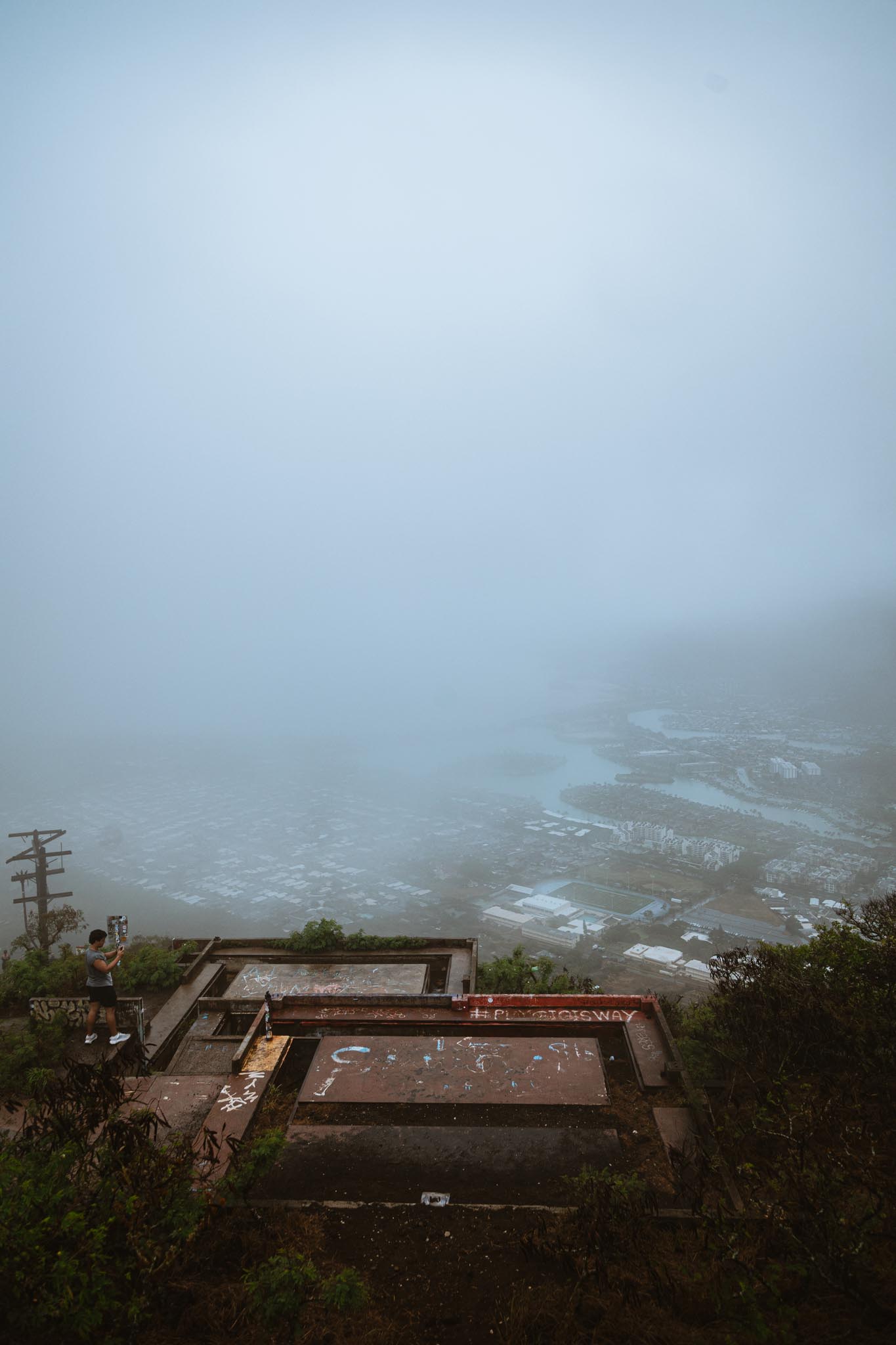 Bunker ruins above a fog-erased valley