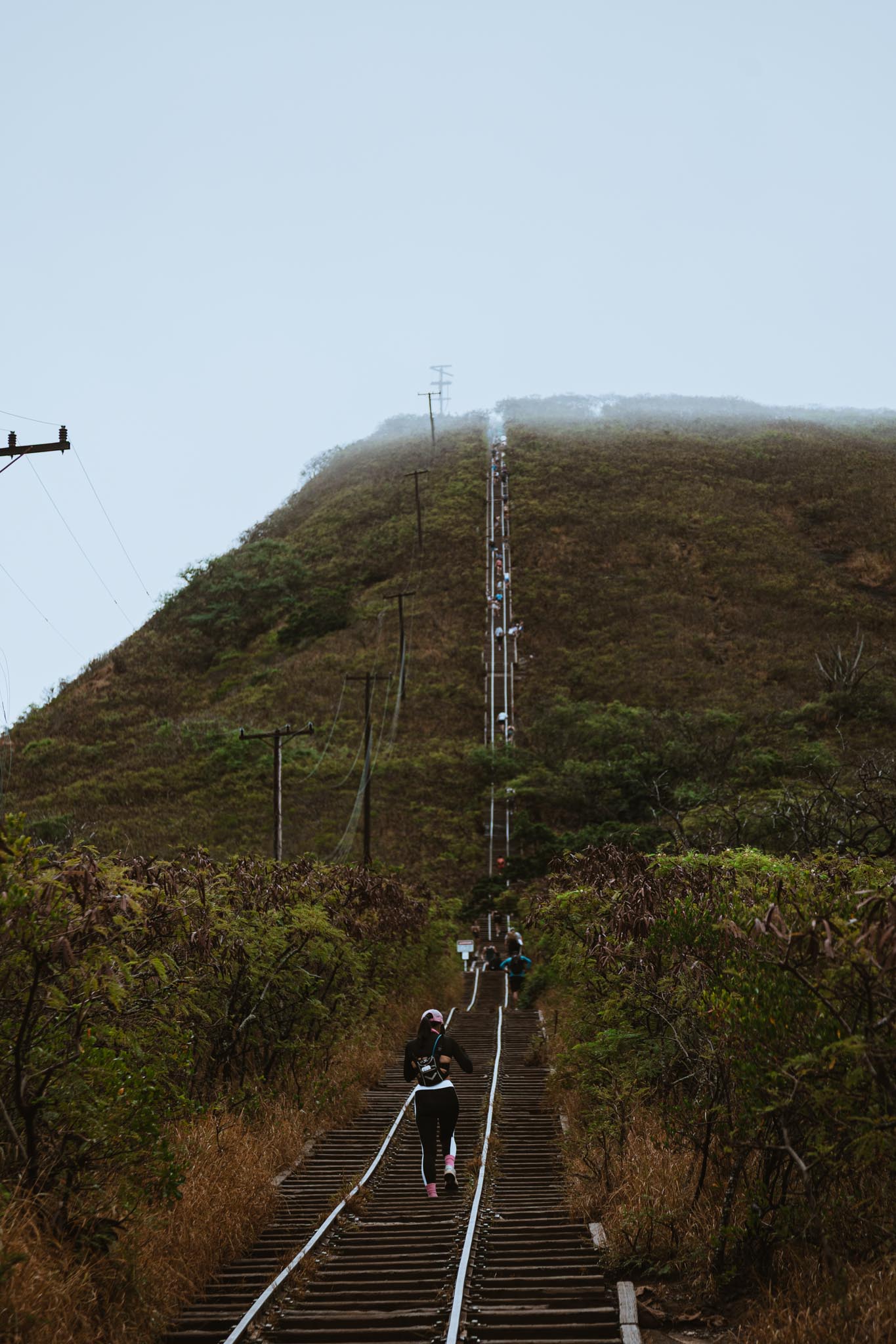 Hiker mid-stride on the rail-tie stairs